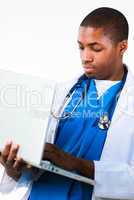 Portrait of an young African doctor working on a laptop