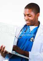 Friendly Afro-American doctor working on a laptop