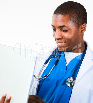 Close-up of an friendly Afro-American doctor working on a laptop