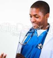 Close-up of an friendly Afro-American doctor working on a laptop