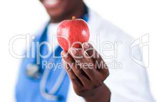 Close-up of an Smiling doctor holding an apple