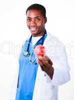 Smiling doctor holding an apple with focus on doctor
