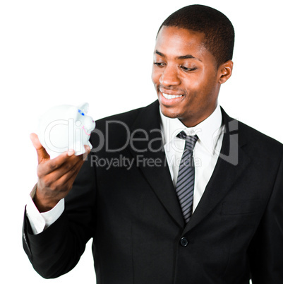 Close-up of an young businessman looking at a piggy bank