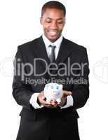Portrait of an handsome businessman holding a piggy bank