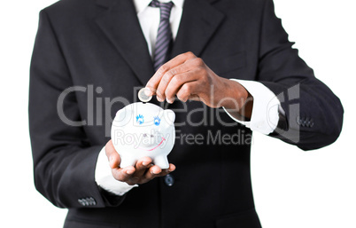 Close-up of a Businessman putting money in his piggy bank