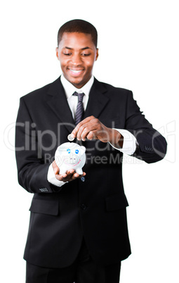 Businessman putting money in his piggy bank