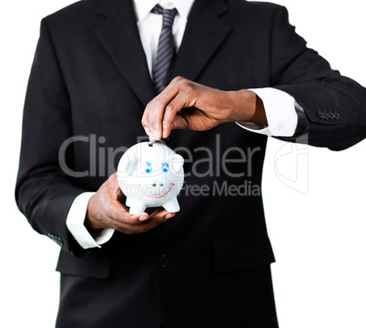 Close-up of a Businessman putting money in his piggy bank