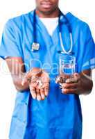 Young doctor holding pills and glass of water