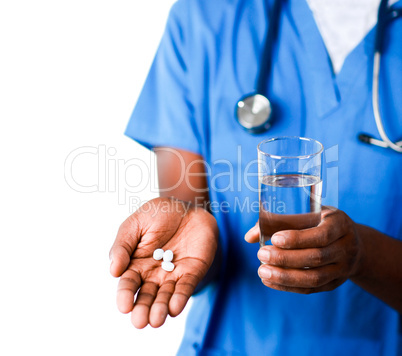 Close-up of an Young doctor holding pills and glass of water