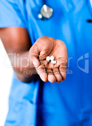 Close-up of an doctor holding pills and glass of water