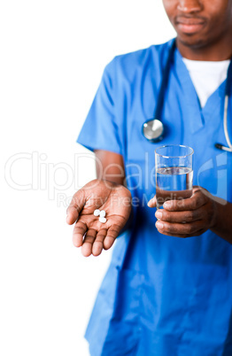 Confident doctor holding pills and glass of water