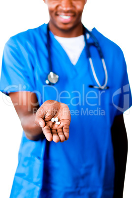 Friendly doctor holding pills and glass of water
