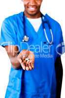 Friendly doctor holding pills and glass of water