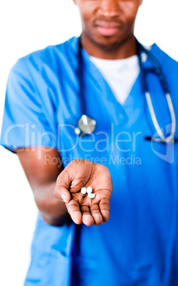 Serious doctor holding pills and glass of water