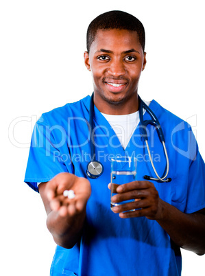 Friendly doctor in scrubs with pills and glass of water