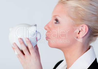 Woman kissing a piggy Bank