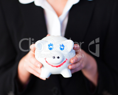 Young woman holding a funky piggy bank