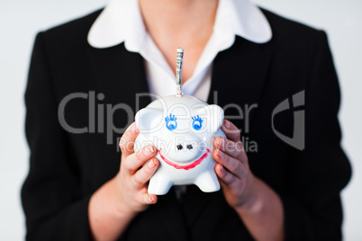 Woman Holding a piggy bank with dollars in it