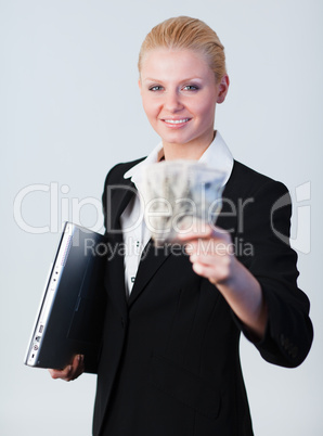 woman holding dollars and a laptop