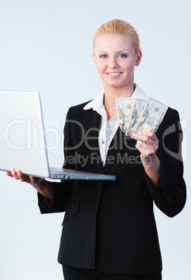 woman holding dollars and a laptop