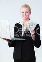 woman holding dollars and a laptop