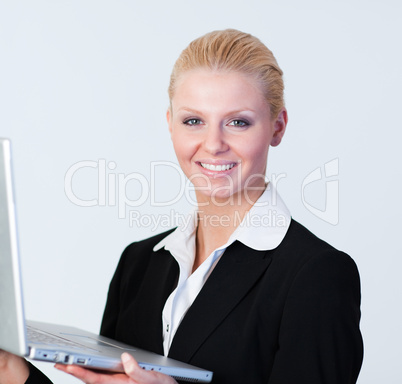 Happy Businesswoman holding a laptop