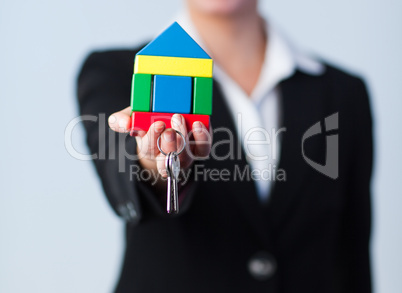 Woman holding house and dollars