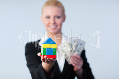 Businesswoman with house and dollars