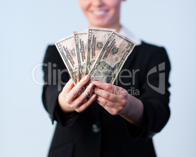 Business woman holding up dollars