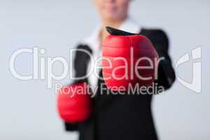 Business woman with boxing gloves on