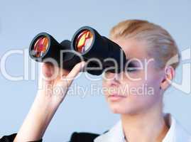 Serious business woman looking into Binoculars