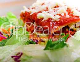 Close up of Lasagana with salad