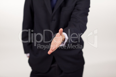 businessman showing a handshake to the camera