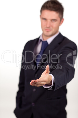 businessman showing a handshake to the camera