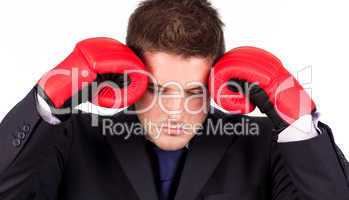 businessman with boxing gloves to his head