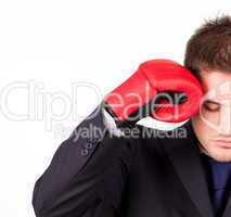 businessman with boxing gloves to his head