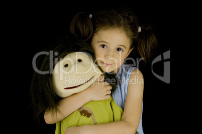 sweet little girl embraces her favorite doll