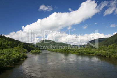 A river landscape with clouds.