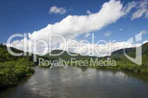 A river landscape with clouds.