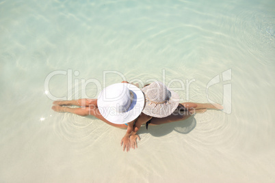 Woman lying in blue pool