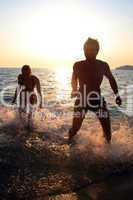 dancing on the beach during a sunset