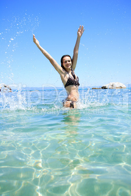 tanned blond woman in bikini in the sea