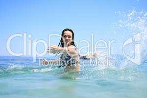 tanned blond woman in bikini in the sea