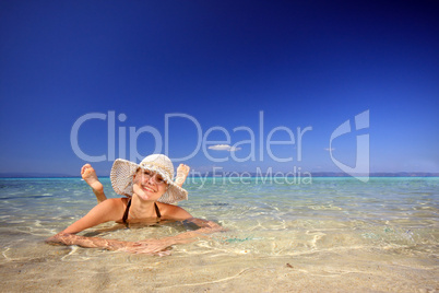 tanned blond woman in bikini in the sea