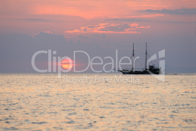 Sailboat during sunset above the sea