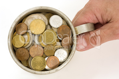 Old aluminum mug and coins.