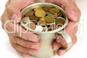 Old aluminum mug and coins.