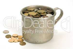 Old aluminum mug and coins.