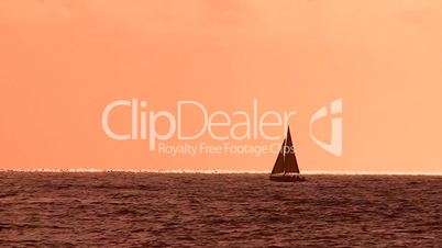 Sailboat sailing at sunset