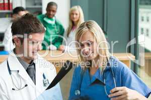 Doctors reading a document in hospital